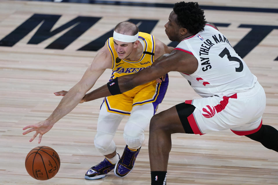 Toronto Raptors' OG Anunoby (3) tries to steal the ball from Los Angeles Lakers' Alex Caruso during the first half of an NBA basketball game Saturday, Aug. 1, 2020, in Lake Buena Vista, Fla. (AP Photo/Ashley Landis, Pool)