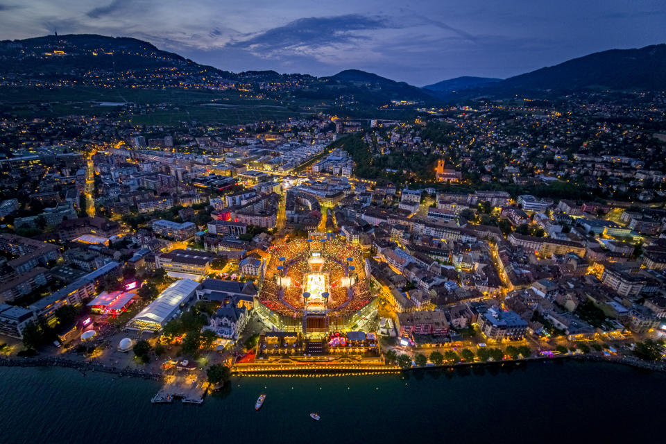 An aerial view shows the full arena of the "Fete des Vignerons" (winegrowers' festival in French), with a capacity of 20,000 spectators and hosting a giant central LED floor of approximately 800 square meters, during the crowning ceremony of the opening night in Vevey, Switzerland Thursday, July 18, 2019. Organized in Vevey by the brotherhood of winegrowers since 1979, the event will celebrate winemaking from July 18 to August 11 this year. (Valentin Flauraud/Keystone via AP)