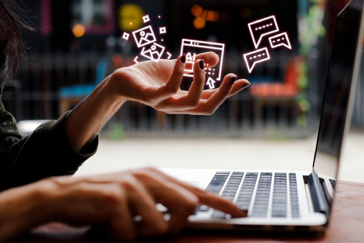 woman typing holding AI symbols
