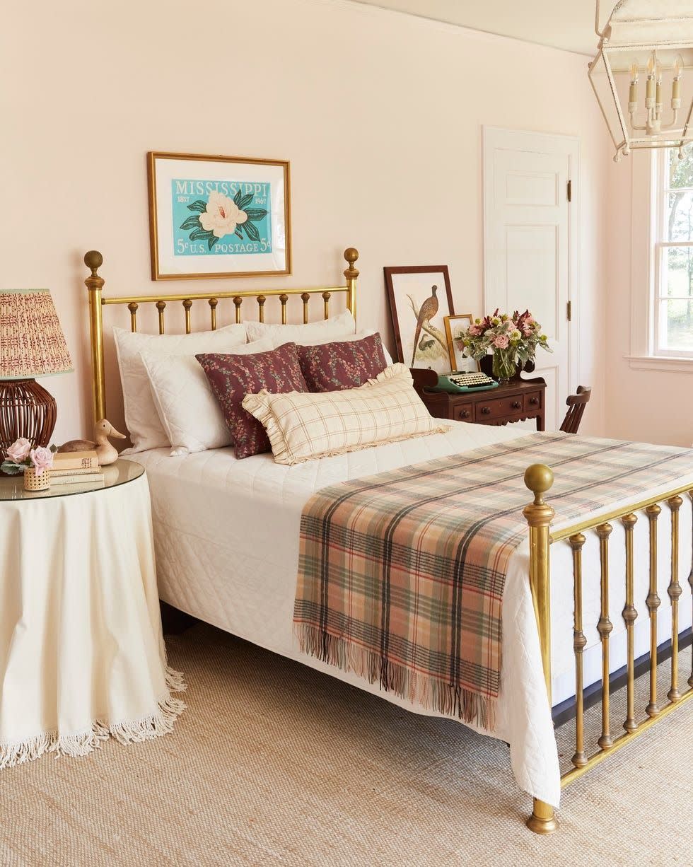 pale pink bedroom with brass bed