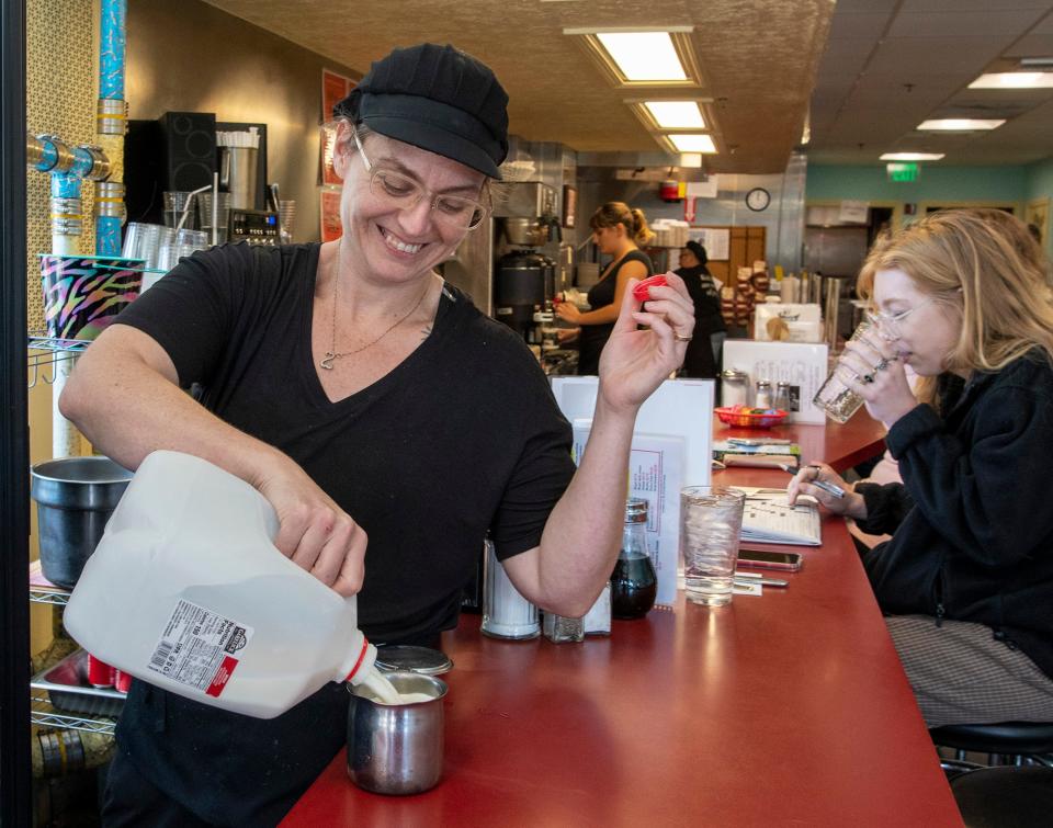 Megan Zawalich fills a creamer during a busy time Friday at Annie’s Clark Brunch.