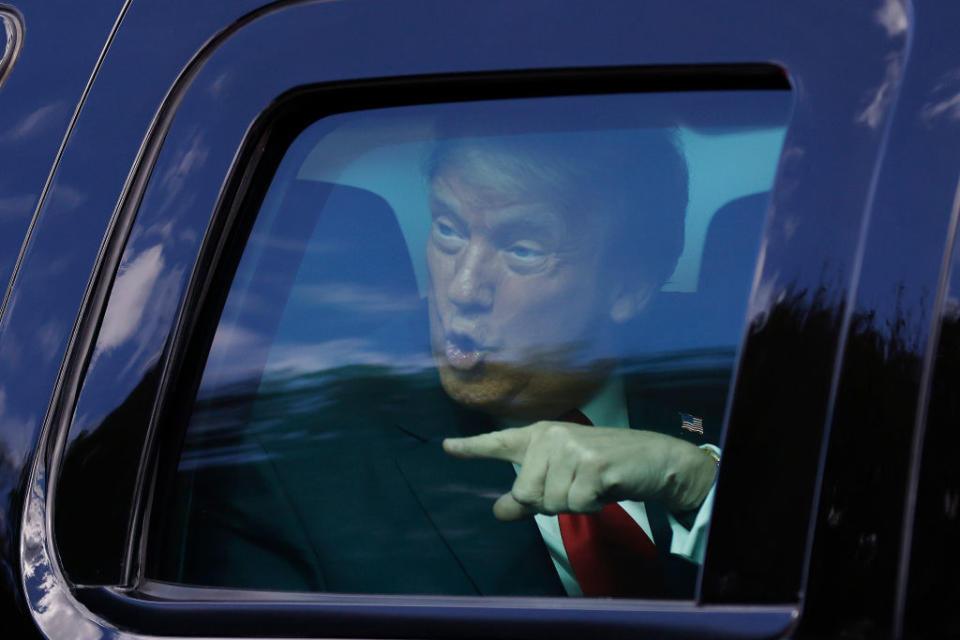 Outgoing US President Donald Trump waves to supporters lined along on the route to his Mar-a-Lago estate in West Palm Beach, Florida.