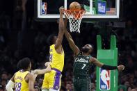 Boston Celtics' Jaylen Brown (7) fouls Los Angeles Lakers' Thomas Bryant (31) during the first half of an NBA basketball game, Saturday, Jan. 28, 2023, in Boston. (AP Photo/Michael Dwyer)