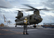 In this photo provided by the Australia Defense Force HMAS Adelaide embarks Chinook Heavy-Lift Helicopters, Wednesday, Jan. 19, 2022, before departing the port of Brisbane, Australia, to provide humanitarian assistance to the Government of Tonga. U.N. humanitarian officials report that about 84,000 people — more than 80% of Tonga's population — have been impacted by the volcano's eruption. (LSIS David Cox/Australian Defence Force via AP)