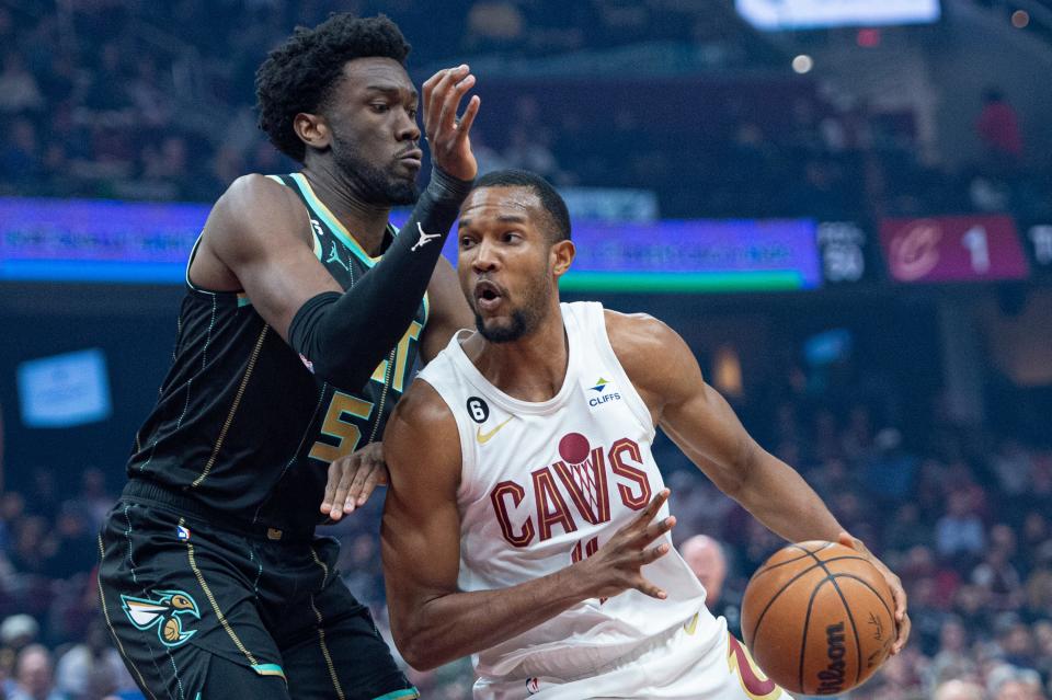 Cleveland Cavaliers' Evan Mobley (4) drives against Charlotte Hornets' Mark Williams (5) during the first first half of an NBA basketball game in Cleveland, Sunday, April 9, 2023. (AP Photo/Phil Long)