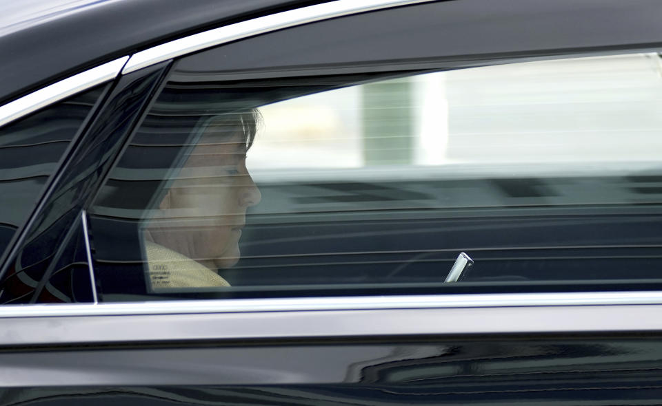 German Chancellor Angela Merkel looks at a mobile device as she leaves the headquarters of the German Christian Democratic Party (CDU) in a car in Berlin, Germany, Monday, Sept. 13, 2021. (AP Photo/Michael Sohn)