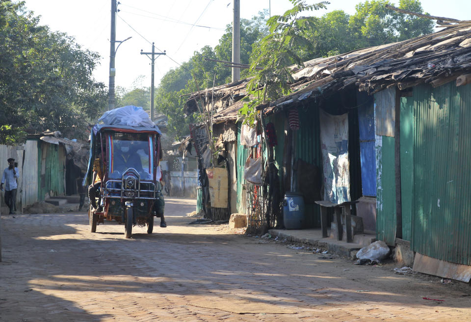 Rohingya refugees who are being moved to an island called 'Bhasan Char' travel in an auto rickshaw as they leave a refugee camp in Kutipalong, Bangladesh, Monday, Dec. 28, 2020. Officials in Bangladesh sent a second group of Rohingya refugees to an isolated island in the Bay of Bengal on Monday, despite calls by human rights groups for a halt to the process. More than 30 buses carrying about 1,500 refugees left their camps in Cox’s Bazar district on the way to the island, a government official involved with the process said. (AP Photo/Shafiqur Rahman)