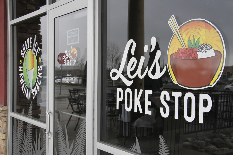 The exterior of Lei's Poke Stop is seen Wednesday, April 17, 2019, in Anchorage, Alaska. Hawaii lawmakers are considering adopting a resolution calling for the creation of legal protections for Native Hawaiian cultural intellectual property. The move comes after a Chicago restaurant chain owner shocked the island state by trademarking the name "Aloha Poke" and sending letters to similarly named cubed fish shops around the country demanding that they change their names, including this Anchorage store, which changed its name. (AP Photo/Mark Thiessen)