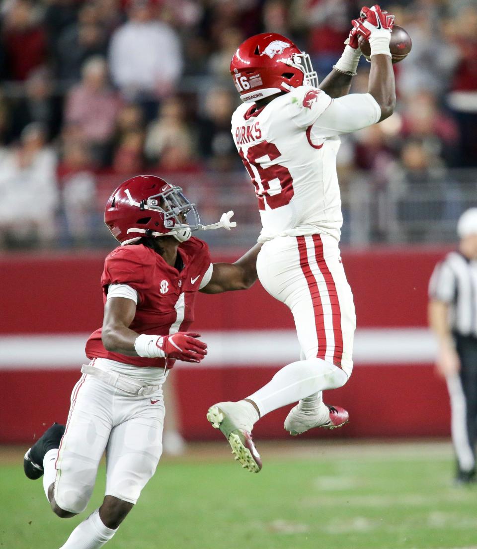 Nov 20, 2021; Tuscaloosa, Alabama, USA;  Arkansas wide receiver Treylon Burks (16) makes a catch over Alabama defensive back Kool-Aid McKinstry (1) at Bryant-Denny Stadium. Alabama defeated Arkansas 42-35. Mandatory Credit: Gary Cosby Jr.-USA TODAY Sports