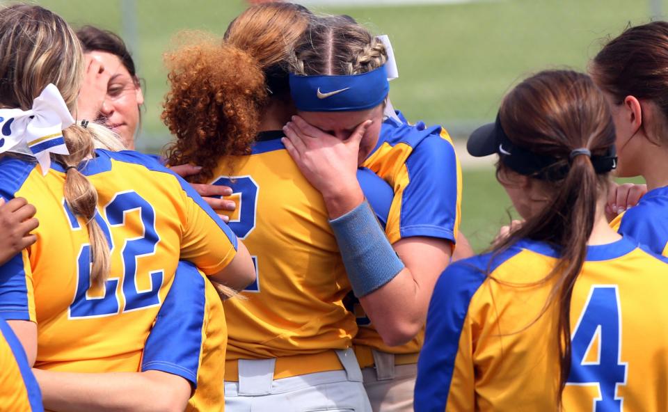 Gahanna Lincoln's Juju Morris consoles Ella Esterby, facing, following the Lions' 1-0 loss to Lancaster in a Division I regional semifinal May 25 at Centerburg. Lancaster won on a walk-off home run by Reese Poston.