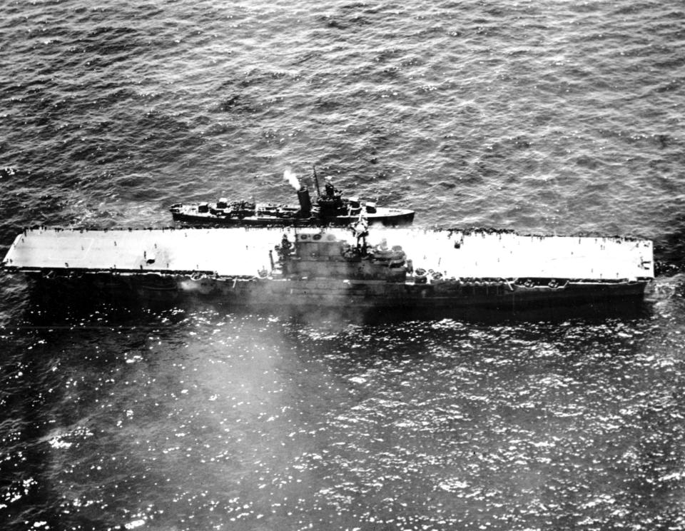FILE - In this Oct. 26, 1942 file photo, the stricken aircraft carrier USS Hornet lies dead in the waters after a morning attack by Japanese warplanes during the Battle of Santa Cruz in the South Pacificduring World War II. A research vessel funded by the late Seattle billionaire Paul Allen has discovered the wreckage of the aircraft carrier sunk in the South Pacific. Allen's Vulcan Inc. announced this week of Feb. 10, 2019, that an autonomous submarine sent by the crew of the research vessel Petrel found the USS Hornet nearly 17,500 feet (5,400 meters) deep near the Solomon Islands. The Hornet was best known for its part in the Doolittle Raid in April 1942, the first air attack on Japan. (AP Photo)