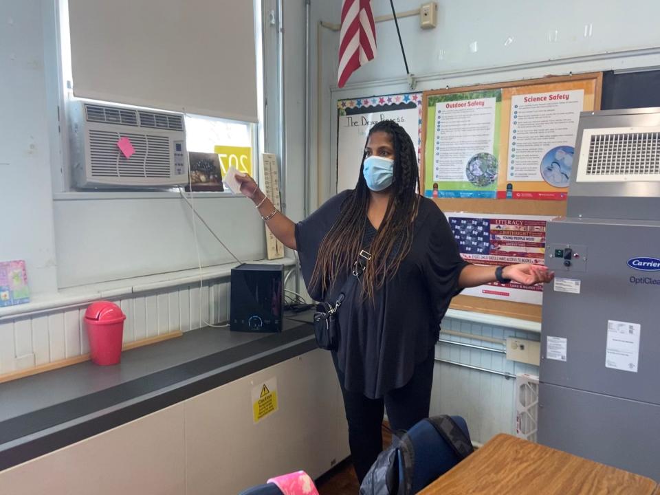 Madelynn Walker must speak loudly enough to overcome the thrum from the locker-size air purifier in her room at Paterson School 19. The pink note on the air conditioner window unit says it's broken.