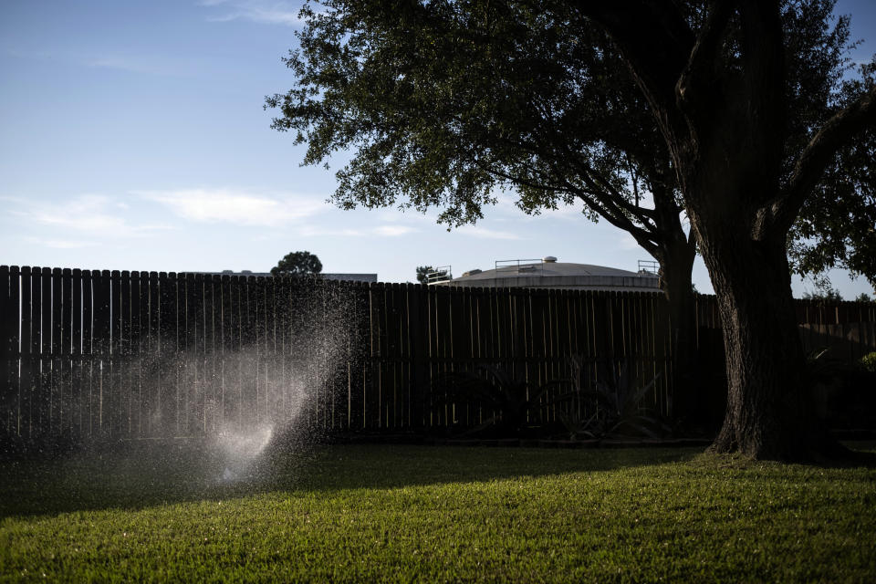 Image: a sprinkler on a lawn in Prestonwood Forest. (Lizzie Chen / for NBC News)