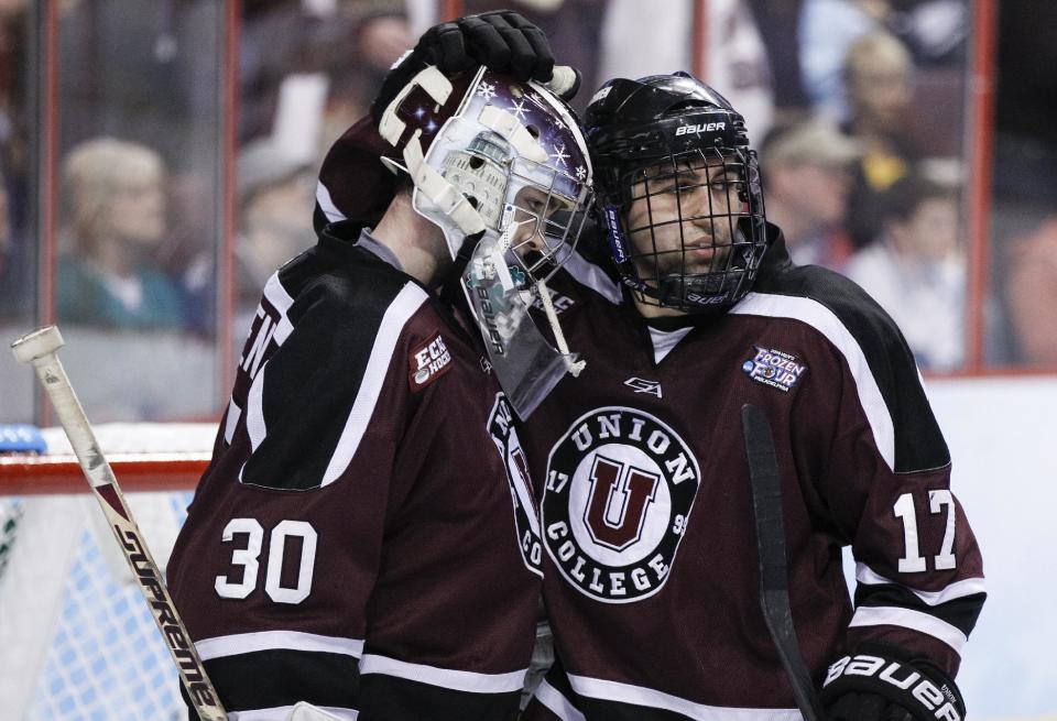 Union's Colin Stevens, left, celebrates the win with Daniel Ciampini, right, following the third period of an NCAA men's college hockey Frozen Four tournament game against Boston College, Thursday, April 10, 2014, in Philadelphia. Union College won 5-4. (AP Photo/Chris Szagola)