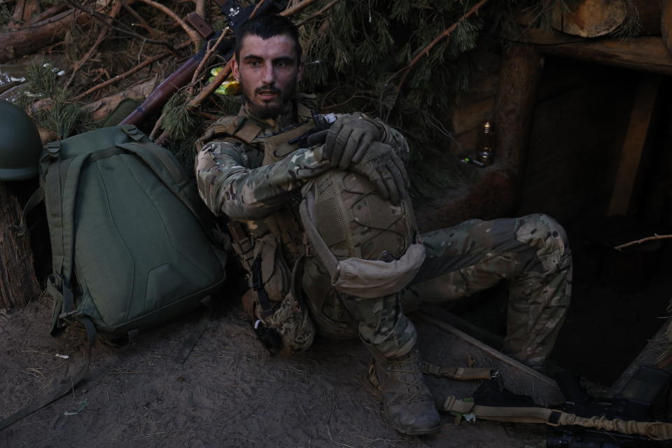 A Ukrainian soldier rests in a trench on the frontline near Kreminna, Luhansk region, Ukraine, Thursday, June 8, 2023. (Roman Chop via AP)