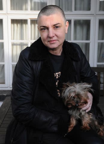 <p>Getty</p> Irish singer and song-writer Sinead O'Connor posed with a pet dog at her home in County Wicklow