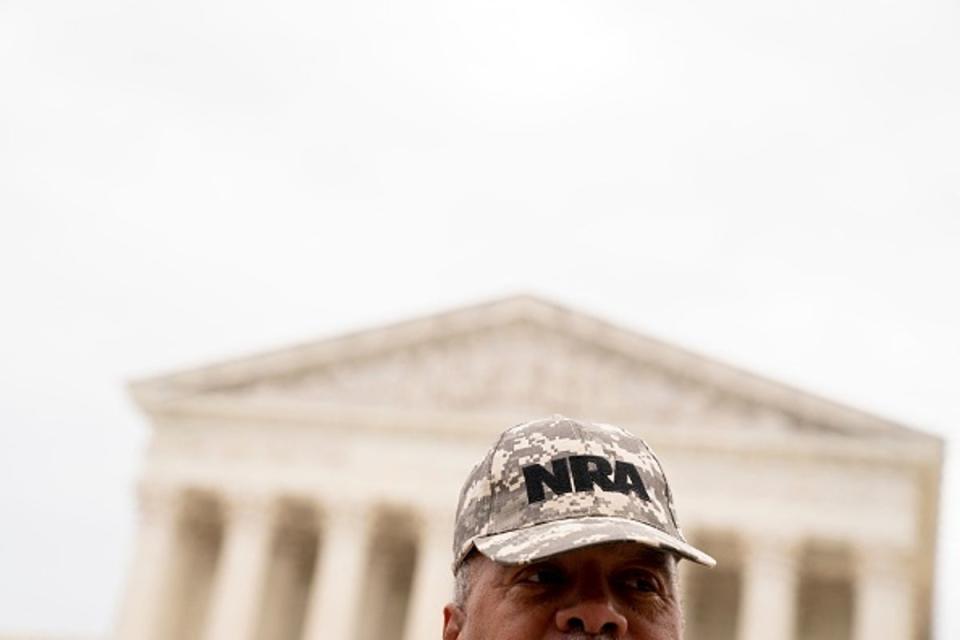 A person wears an NRA hat in front of the US Supreme Court in Washington, DC, on 21 June 2022. (AFP via Getty Images)