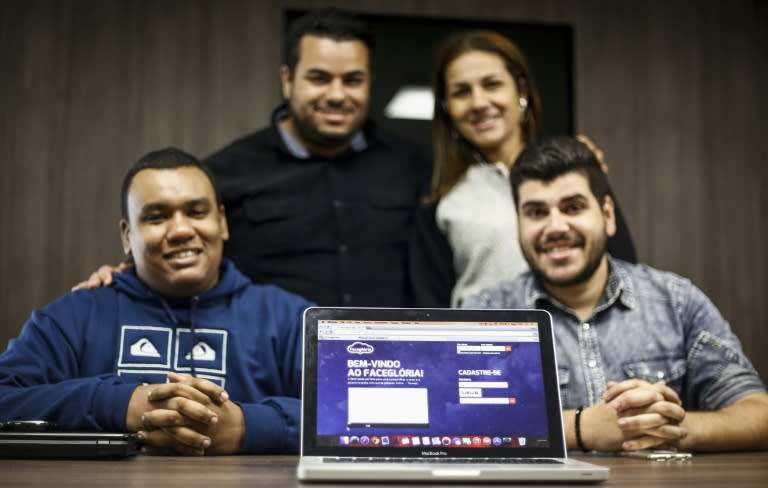 (From L) Thiago, Davis, Daiane and Atilla, creators of the social network for evangelicals, Facegloria, pose for a photo during an interview in Sao Paulo, Brazil