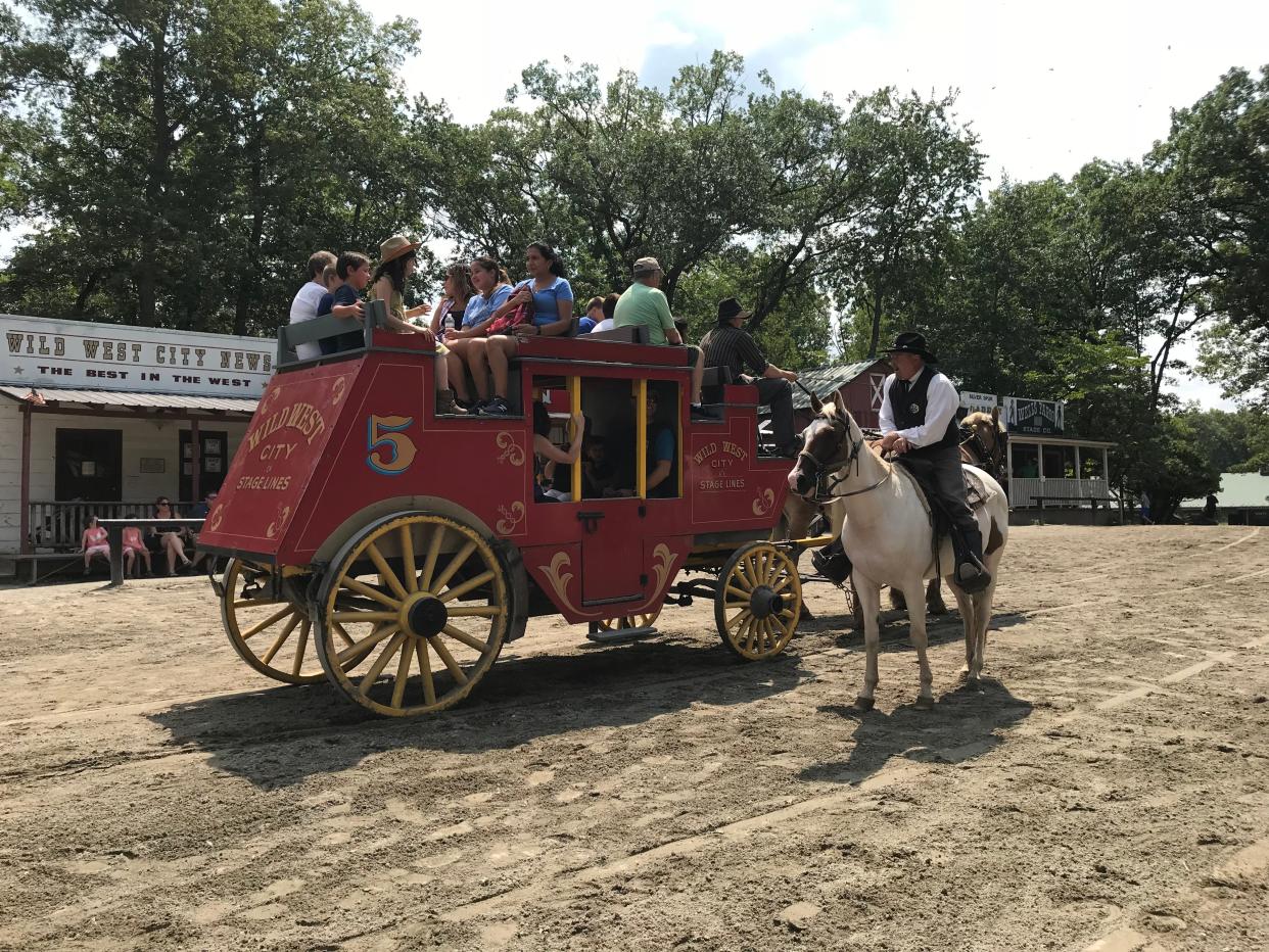 The marshal at Wild West City, a western-themed seasonal park in Byram, N.J., checks in on stagecoach passengers on Aug. 15, 2018.