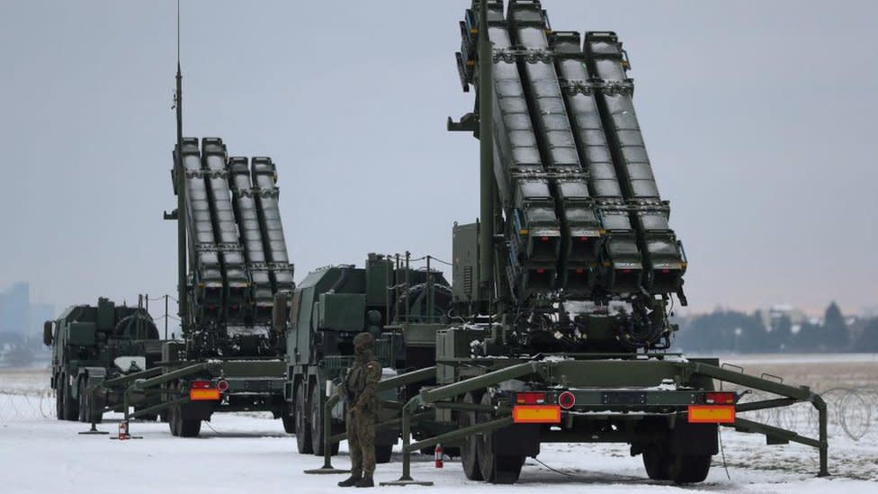 Serviceman patrols in front of the Patriot air defence system during Polish military training on the missile systems at the airport in Warsaw, Poland February 7, 2023