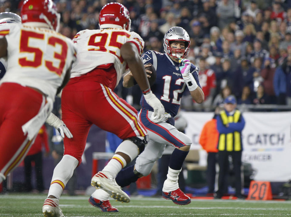 New England Patriots quarterback Tom Brady (12) runs past Kansas City Chiefs linebacker Anthony Hitchens (53) and defensive tackle Chris Jones (95) for a touchdown during the second half of an NFL football game, Sunday, Oct. 14, 2018, in Foxborough, Mass. (AP Photo/Michael Dwyer)