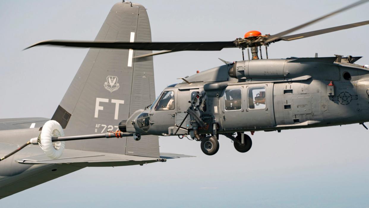 An HH-60W Jolly Green II connected with a HC-130J