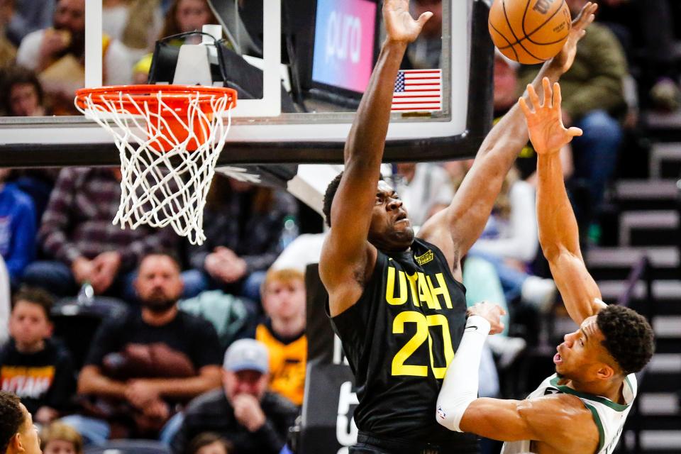 Utah Jazz center Udoka Azubuike (20) defends against a shot by Milwaukee Bucks forward Giannis Antetokounmpo (right) during the first half of an NBA basketball game on March 24, 2023, in Salt Lake City.