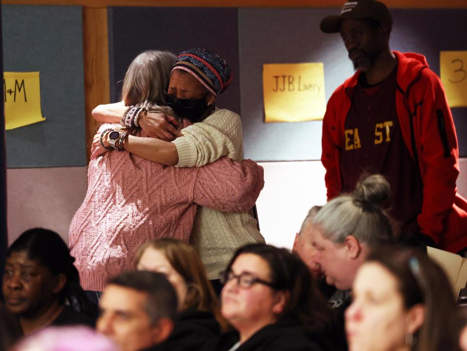 Educator Julie Fairfield, left, is hugged after speaking at a special Brockton school committee meeting at the Arnone School on Wednesday, Jan. 31, 2024.