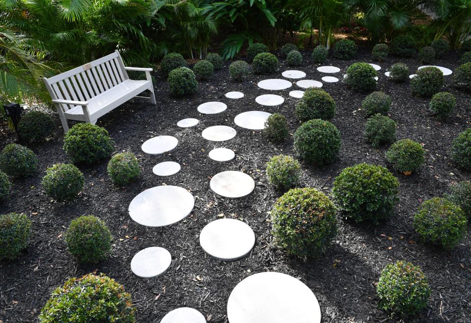 A footpath of circular stepping stones and spherical topiaries in the "Shear Repetition" display continue Yayoi Kusama's signature theme.