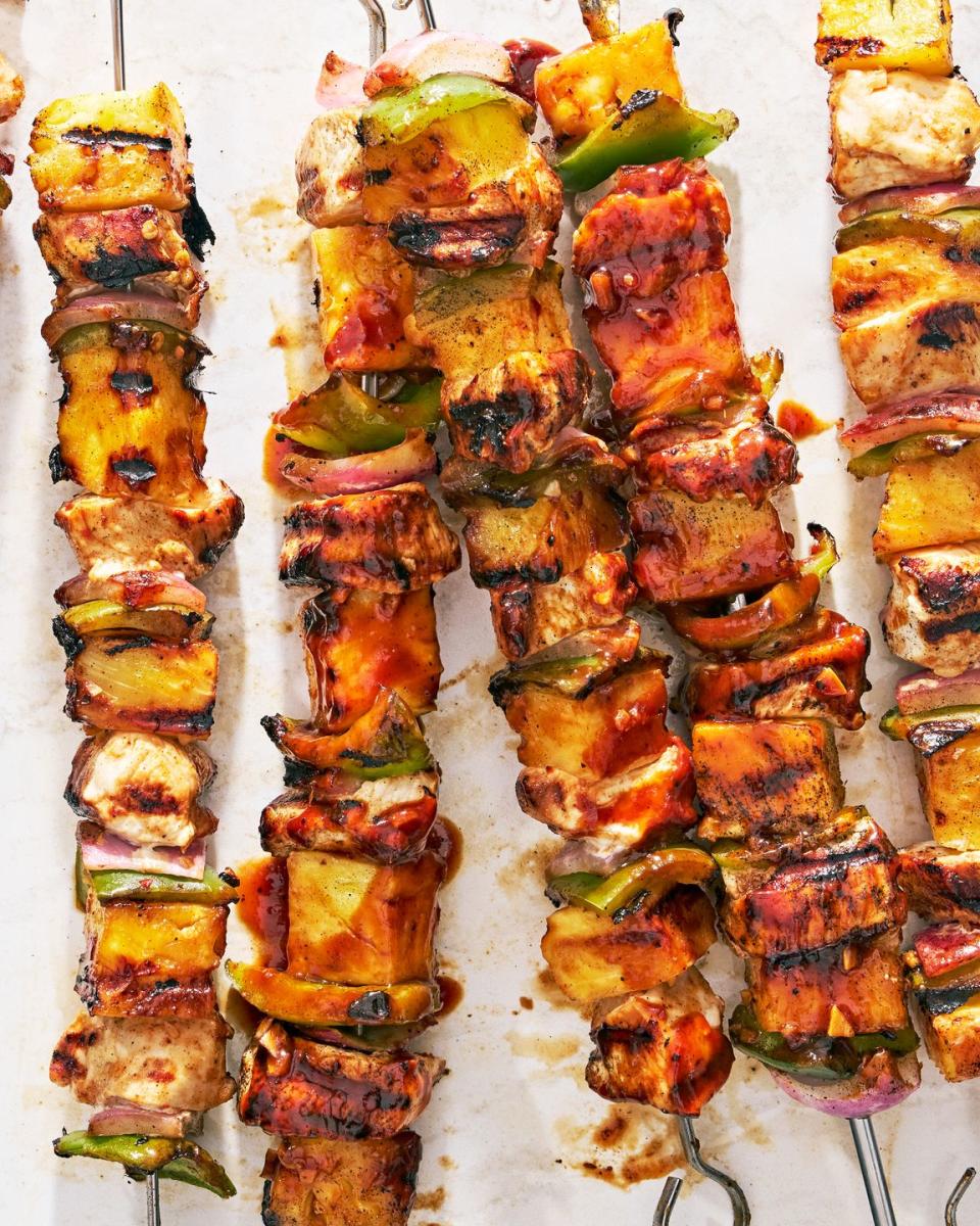 chicken, pineapple, and peppers on a skewer basted with teriyaki