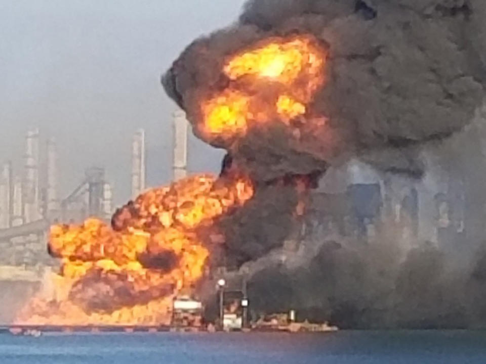 CORRECTS TO PROPANE PIPELINE INSTEAD OF A NATURAL GAS PIPELINE - Coast Guard crews respond to a dredge on fire in the Port of Corpus Christi Ship Channel, Friday, Aug. 21, 2020, in Corpus Christi, Texas. Authorities say several people have been hospitalized after an explosion at the Texas port when a dredging vessel hit a propane gas pipeline in the water. (U.S. Coast Guard via AP)