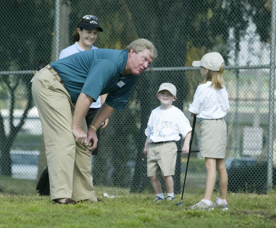 Andy Bean talks with a young golfer in 2003 on the day The First Tee youth golf program announced a Lakeland chapter. Behind him is LPGA golfer Rachel Teske.
