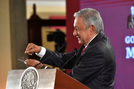 Mexico's President Andres Manuel Lopez Obrador shows a device that had been found in a room used for his meetings in the National Palace headquarters, during his daily news conference in Mexico City