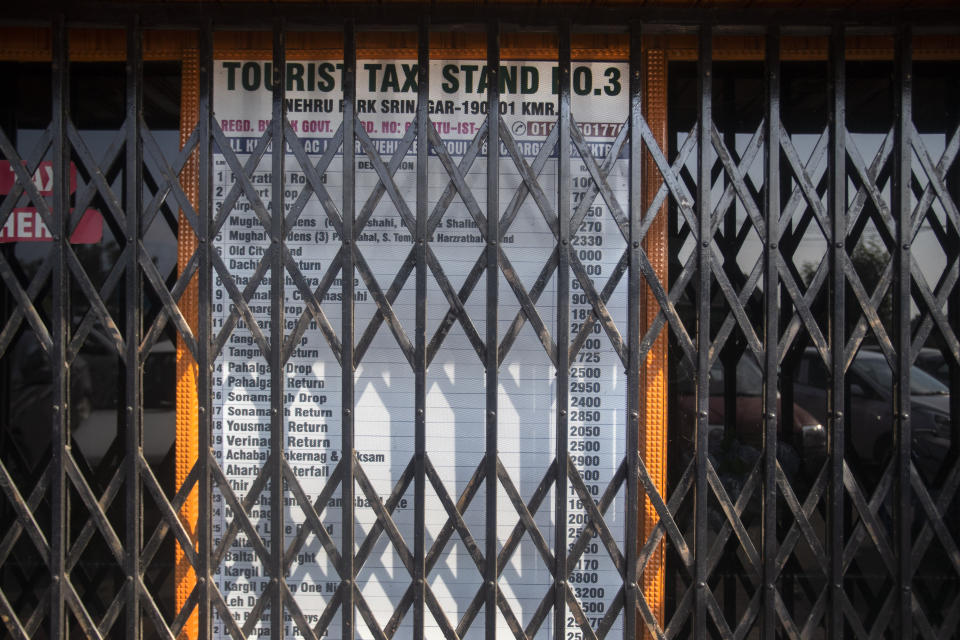 A taxi stand, which is never closed on normal days, is seen shut near the Dal lake in Srinagar, Indian controlled Kashmir,Tuesday, July 28, 2020. Indian-controlled Kashmir's economy is yet to recover from a colossal loss a year after New Delhi scrapped the disputed region's autonomous status and divided it into two federally governed territories. (AP Photo/Mukhtar Khan)