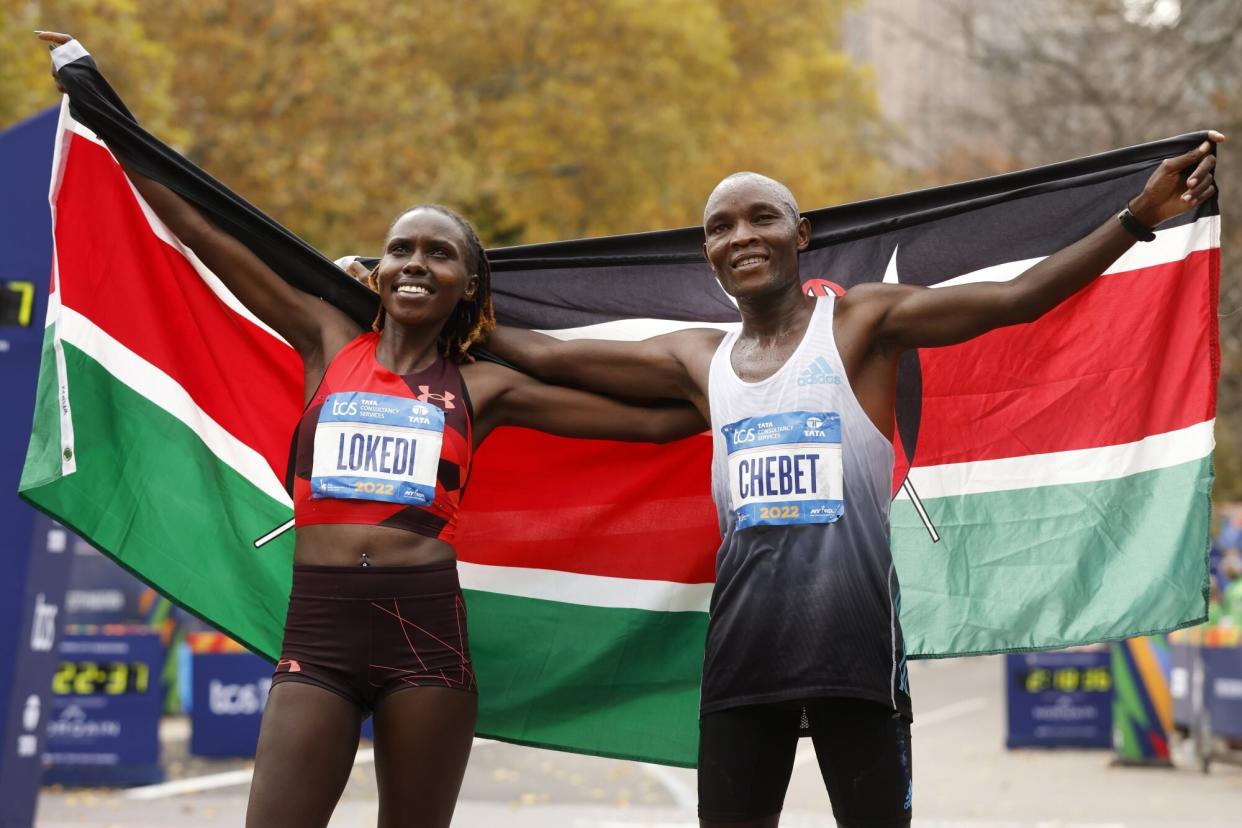 Mandatory Credit: Photo by Jason DeCrow/AP/Shutterstock (13610921t) Women's division winner Sharon Lokedi, of Kenya, and men's division winner Evans Chebet, of Kenya, pose at the finish line of the New York City Marathon, in New York NYC Marathon, New York, United States - 06 Nov 2022