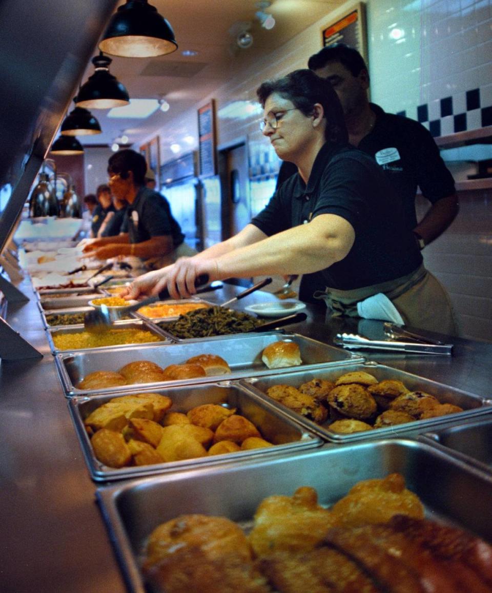 In 1999, server Kim Allen ladles one of 16 side dishes at the grand opening of Piccadilly Cafeteria on University Drive in Davie. Marianne M. Armshaw/Miami Herald File