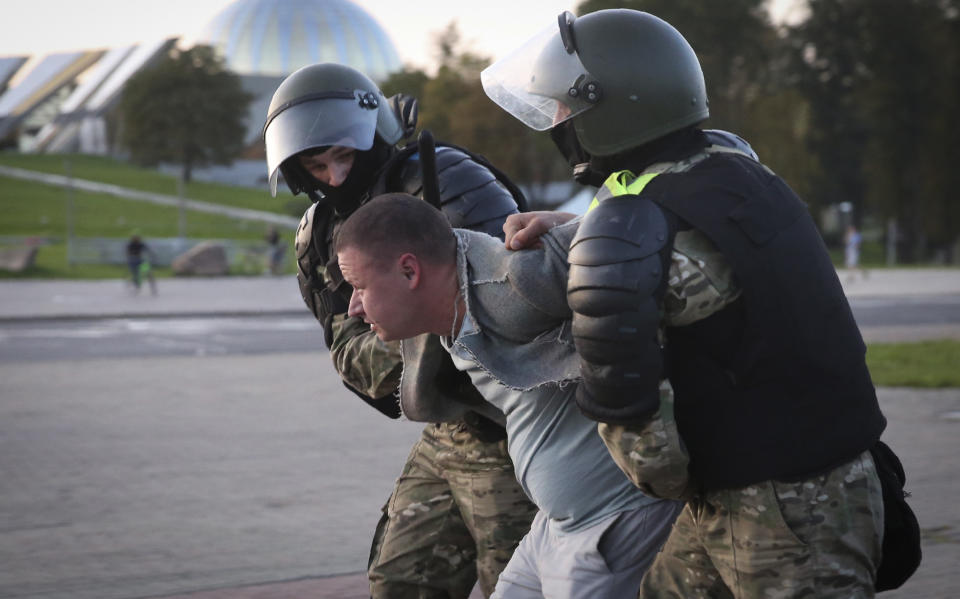 Riot police detain a protester during an opposition rally to protest the presidential inauguration in Minsk, Belarus, Wednesday, Sept. 23, 2020. Belarus President Alexander Lukashenko has been sworn in to his sixth term in office at an inaugural ceremony that was not announced in advance amid weeks of huge protests saying the authoritarian leader's reelection was rigged. Hundreds took to the streets in several cities in the evening to protest the inauguration. (AP Photo/TUT.by)