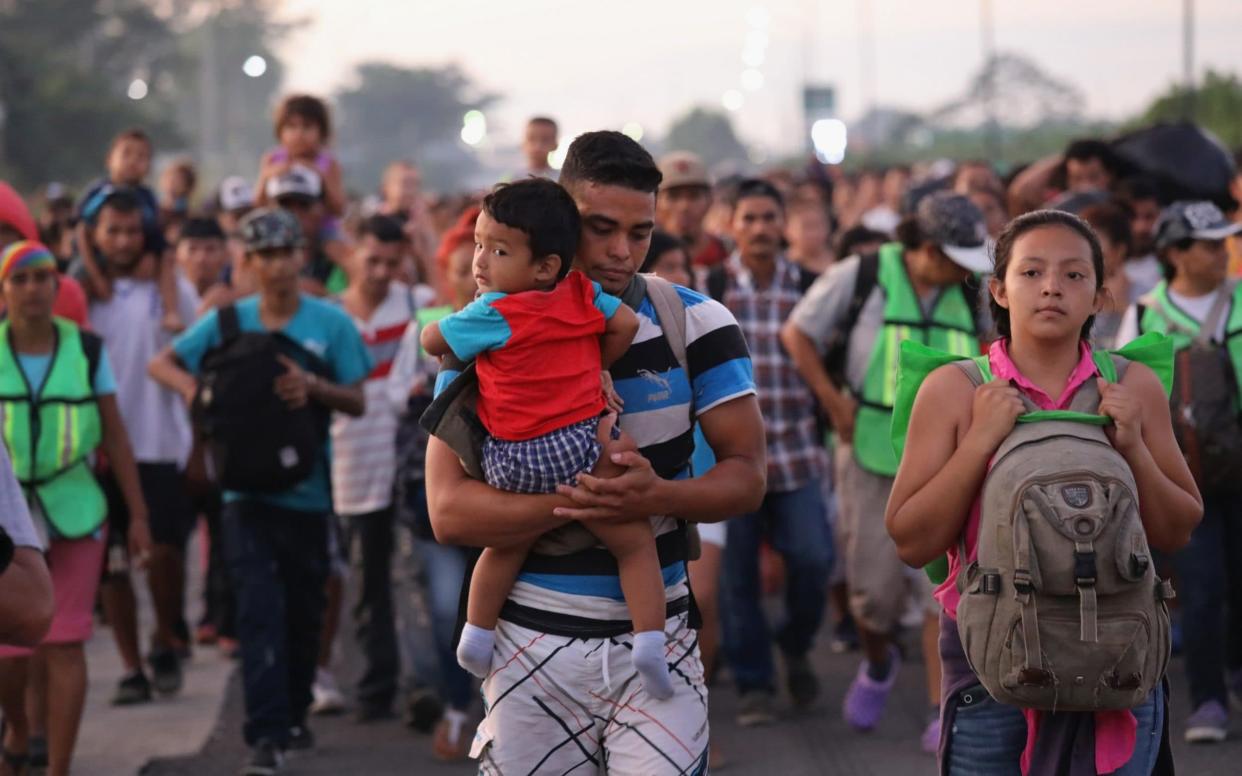 Members of a migrant caravan walk through Mexico after crossing the Guatemalan border - Getty Images South America