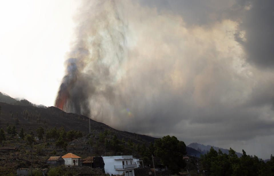 Lava flows from an eruption of a volcano near El Paso on the island of La Palma in the Canaries, Spain, of Monday, Sept. 20, 2021. Lava continues to flow slowly from a volcano that erupted in Spain's Canary Islands off northwest Africa. The head of the islands' regional government says Monday he expects no injuries to people in the area after some 5,000 were evacuated. (AP Photo/Gerardo Ojeda)