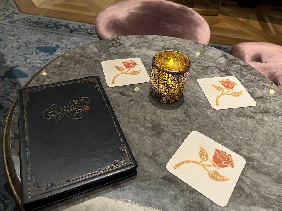 table at enchanted rose in the grand floridian with rose coaster and an embossed menu