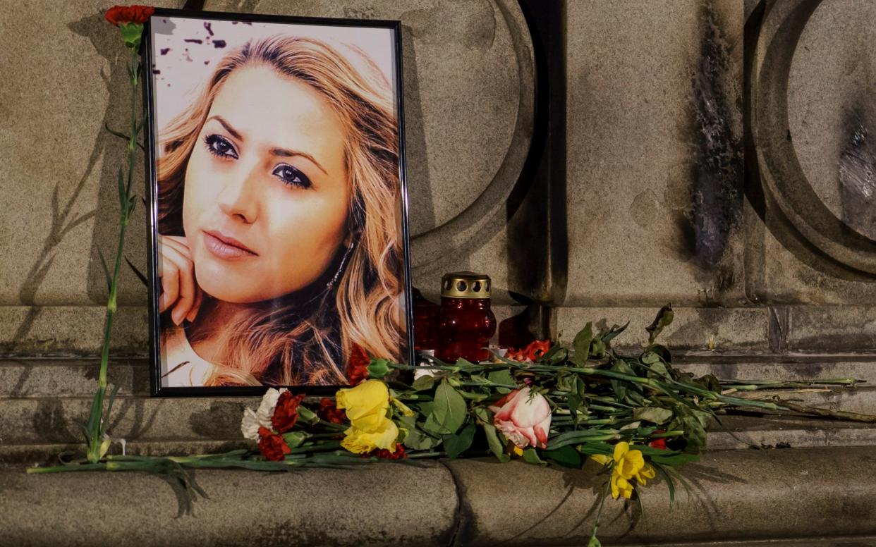 A portrait of slain television reporter Viktoria Marinova is placed on the Liberty Monument during a vigil in Ruse, Bulgaria - AP