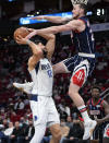 Dallas Mavericks forward Maxi Kleber (42) is fouled by Houston Rockets guard Garrison Mathews during the first half of an NBA basketball game Friday, Jan. 7, 2022, in Houston. (AP Photo/Eric Christian Smith)