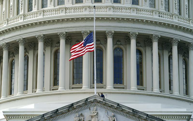 The U.S. flag atop the Capitol is lowered to half-staff