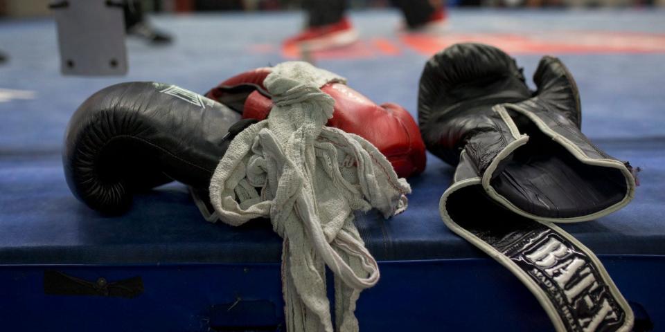 In this Friday, April 29, 2016 file photo, boxing gloves lie on a boxing ring as boxers work out at El Rayo boxing gym in Madrid, Spain.