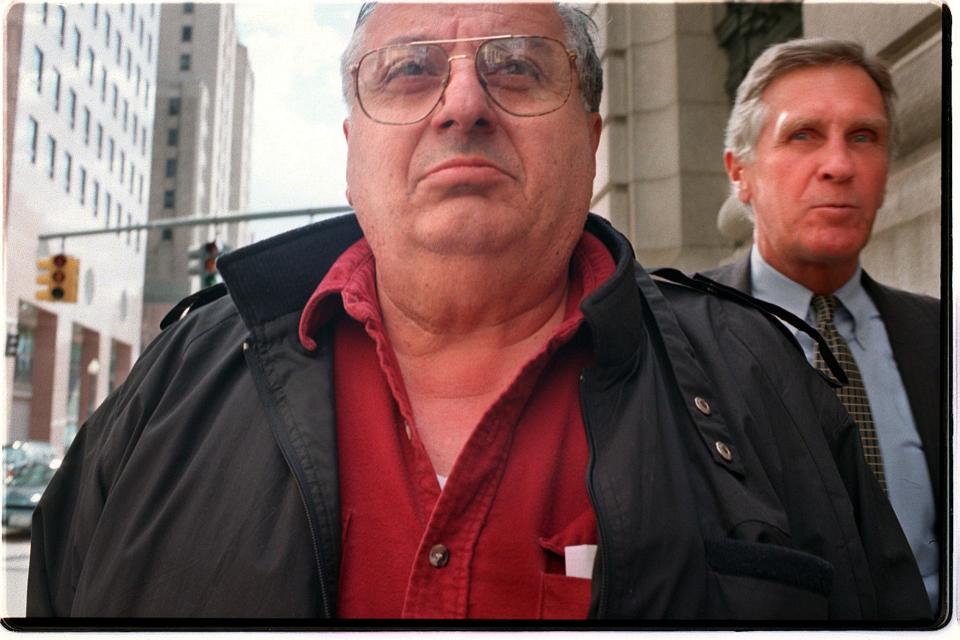 David Ead, vice chairman of the Providence Board of Tax Assessment Review, leaves federal court after being arrested by federal agents. Ead was charged with laundering money to facilitate bribery. At right is his lawyer, former Rhode Island Attorney General James E. O'Neil.