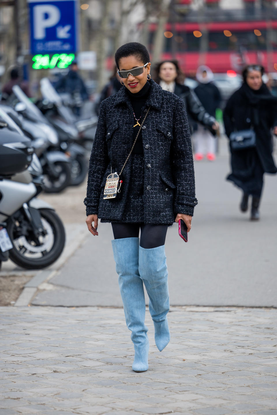 tamu mcphereson in a mini skirt outfit of mini plaid tweed skirt suit and tall blue boots