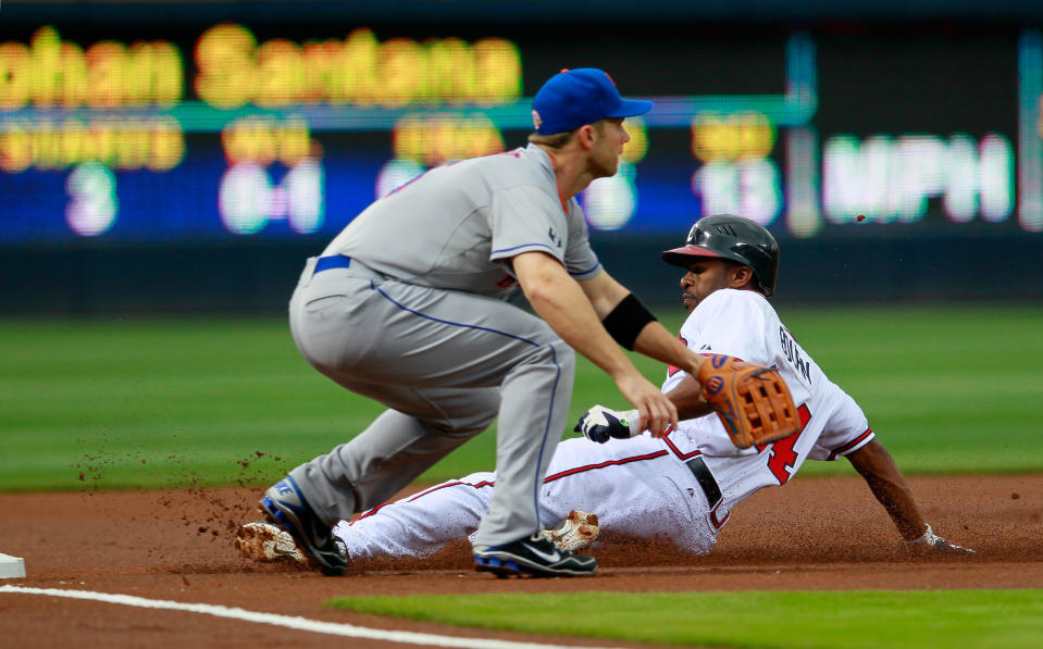 ATLANTA, GA - APRIL 17: Michael Bourn #24 of the Atlanta Braves slides safely into third base against David Wright #5 of the New York Mets at Turner Field on April 17, 2012 in Atlanta, Georgia. (Photo by Kevin C. Cox/Getty Images)