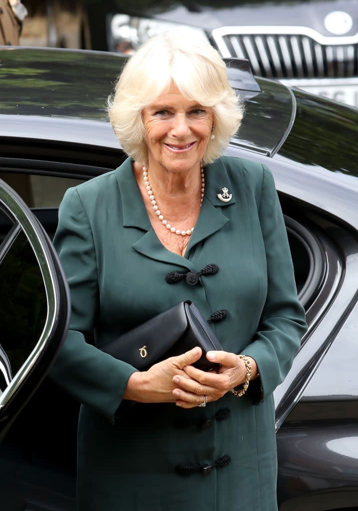 <p>The Duchess of Cornwall stepped out in a dark green ensemble paired with a classic pearl necklace and a sleek black bag while visiting soldiers at the New Normandy Barracks in England.</p>