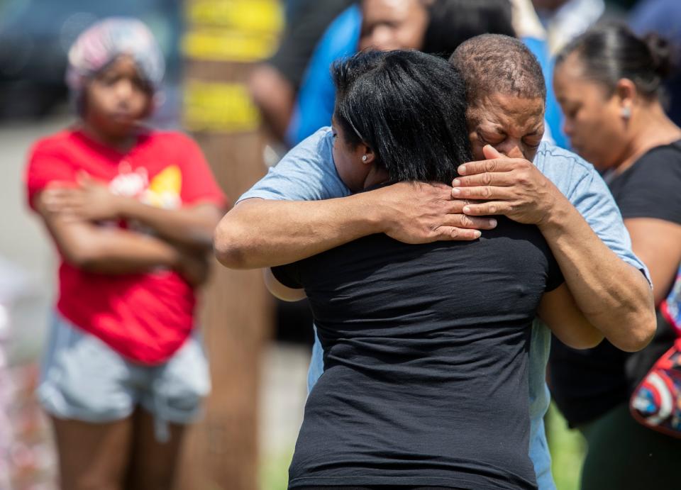 Loved ones are consoled following an officer involved shooting death on Sutcliffe Avenue, in Louisville's West End neighborhood. May 20, 2022