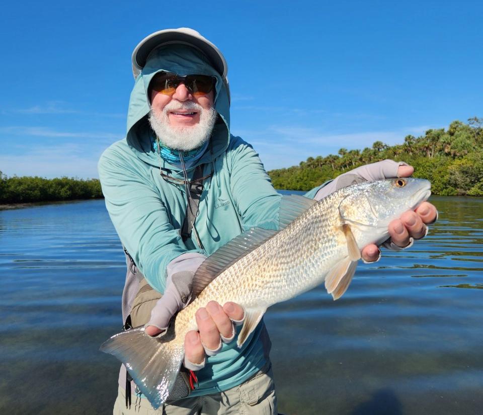 Geno Giza shows off a catch-and-release redfish he caught this past week near Turtle Mound.